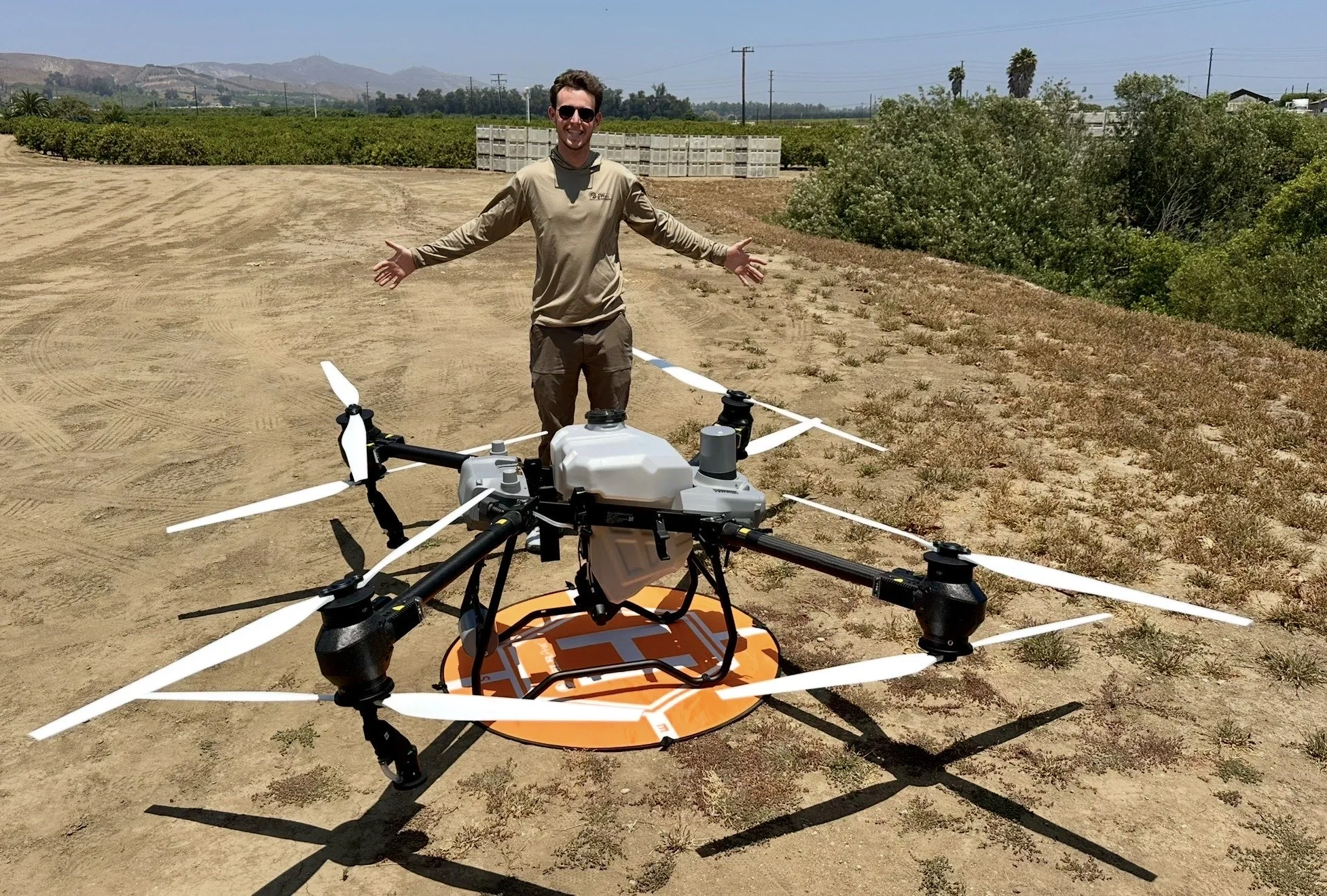Field team member with an agricultural application drone